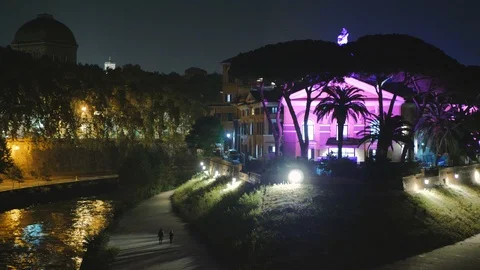The Tiber Island by night with a light that colors the house, the side bridge an Stock Footage