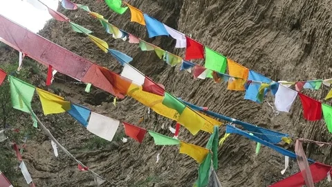 Tibet prayers flapping in the wind at a ancient secluded meditation cave Stock Footage 74642686