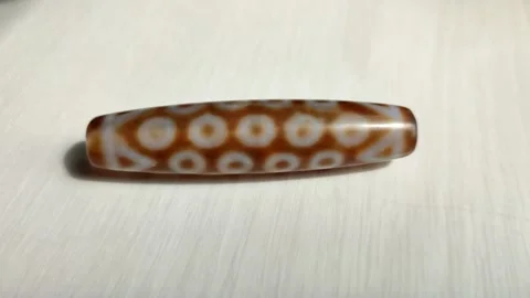 Tibetan amulet agate DZI bead, 9 eyes, close up 動画素材 200948635