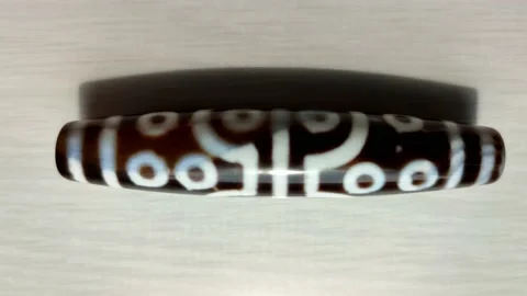 Tibetan amulet agate DZI bead, eyes, close up 動画素材 200948830