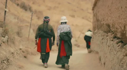 Tibetan Buddhist pilgrims circumambulate Labrang Monastery, Xiahe, China Stock Footage 55768901