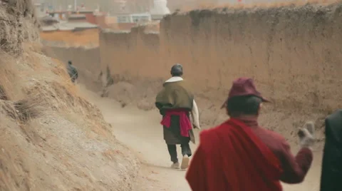 Tibetan Buddhist pilgrims circumambulate Labrang Monastery, Xiahe, China Stock Footage 55769076