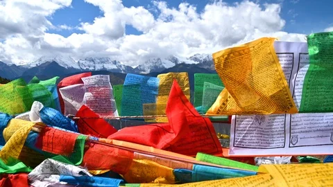 Tibetan buddhist prayer flags blowing in the wind with Meili snow mountain Stock Footage 118917330