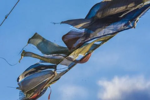 Tibetan flags waving in the wind in the himalayan mountains Stock Photos