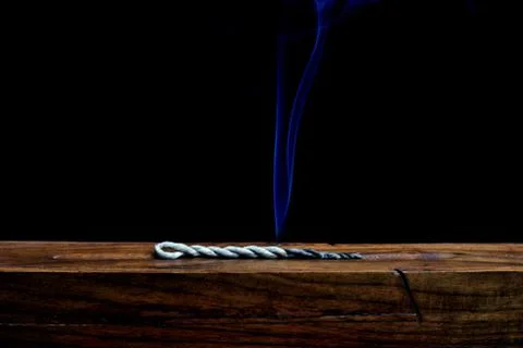 Tibetan lumbini incense rope on a wooden incense burner Stock Photos