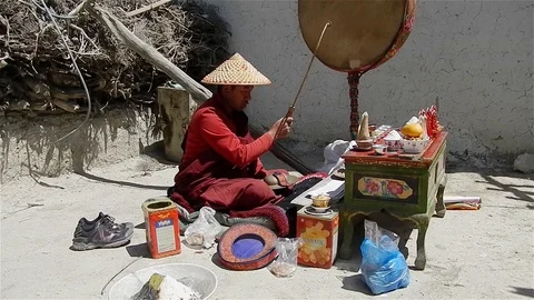 Tibetan monk prays and knocks on the drum Stock Footage 106173161