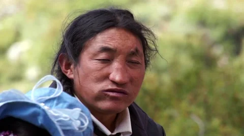 Tibetan pilgrim eats meat and smiling on the camera Stock-Footage 44030534
