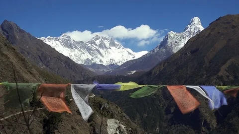 Tibetan prayer flags against white snowy mountain peak in the Everest region of Stock Footage 83413656
