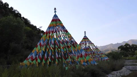 Tibetan prayer flags: colorful rectangular cloth, often found strung along tr Stock Footage 136511993