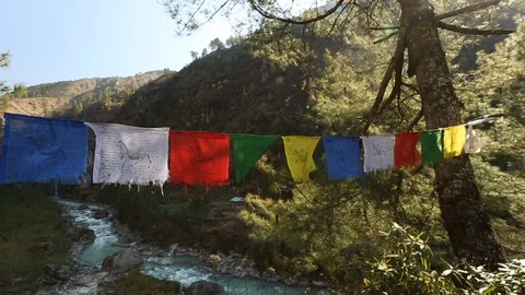 Tibetan prayer flags hanging with river flowing in background 스톡 동영상 101444141