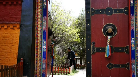 Tibetan walking through the Monastery Door Video stock 37638957
