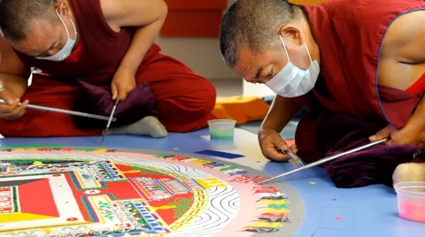 Tibetian monk constructing mandala from colored sand on Week of Tibetian Culture Stock Footage 59149299