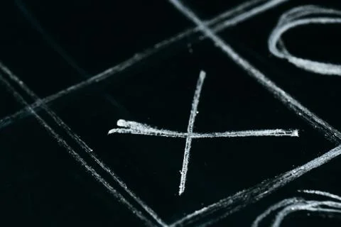 Tic tac toe chalk on a school blackboard dark Stock Photos