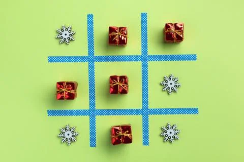 Tic tac toe game with christmas toys, isolated on green background. Christmas Stock Photos