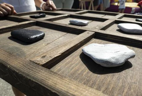 Tic-tac-toe game made with wood and stones Stock Photos