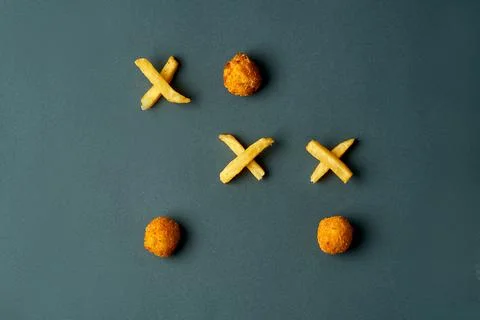 Tic-tac-toe made from fast food. French fries - crosses and mozzarella (zeros Stock Photos