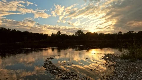 The Ticino river flows slowly at sunset Stock Footage 287957618