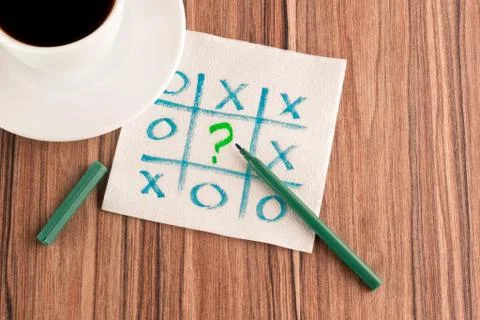 Tick-tack-toe and question mark on a napkin Stock Photos