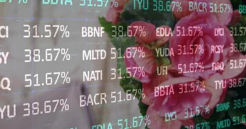 Ticker overlay cycling codes and rates on feed, panning right revealing flowers 스톡 사진