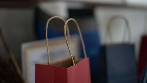 Ticket being placed inside paper bag for a prize drawing Stock Footage 129273794