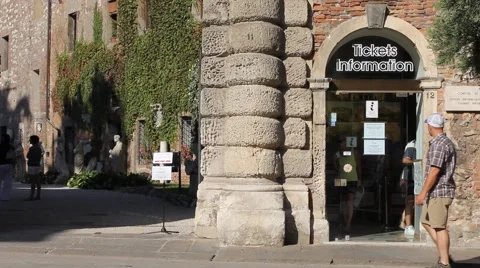 A ticket information point with tourists walking an with bikes Stock Footage 68040008