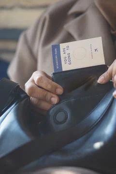 Ticket is pulled from a black bag for a trip Stock Photos