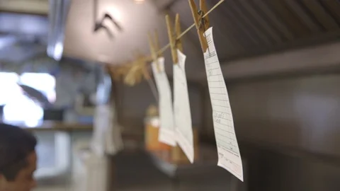 Tickets hanging from restaurant kitchen Stock Footage 104881500