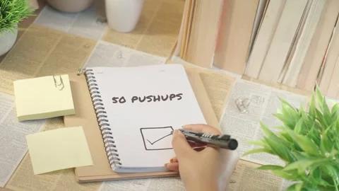 TICKING OFF 50 PUSHUPS FROM CHECKLIST Video stock 308080352