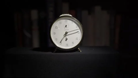 Ticking Clock in front of books Stock Footage 146261866
