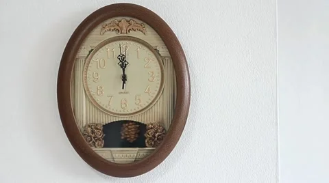 Ticking wall clock showing twelve hours Stock Footage 45805882