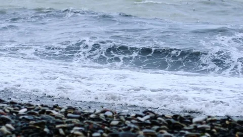 Tidal bore. Pebbles on the shore Stock Footage 74489152
