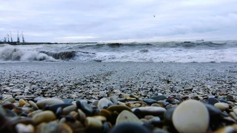 Tidal bore. Pebbles on the shore Stock Footage 74494312