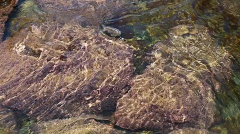 Tidal bore. Stone bottom. Clear water. Stock Photos