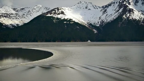 Tidal bore surfer and pan over Cook Inlet, Alaska Stock Footage 76138819