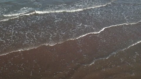 Tidal bore. top view of the sea waves on the beach Stock Footage 240871814