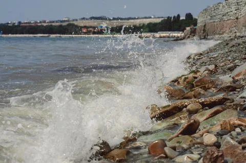 Tidal bore. waves are beating against stones Stock Photos