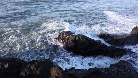 Tidal bore. Waves beat on the rocks Stock Footage 95969473