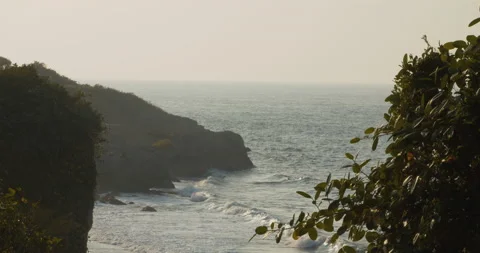 Tidal eave hitting the rocky coastal landscape with shot from the cliff above. 動画素材 135960590