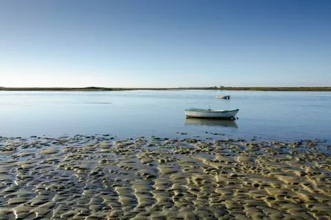 Tidal flat with a small boat Stock Photos