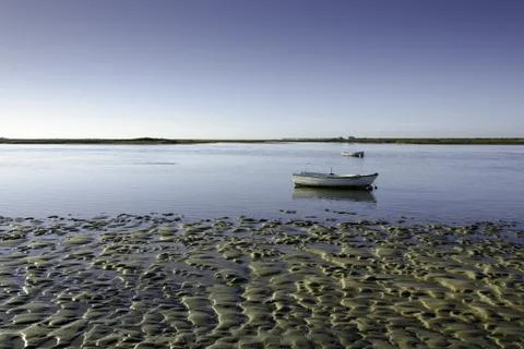 Tidal flat with a small boat Stock Photos