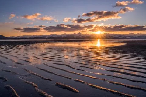 Tidal Flats at low tide at sunset with the Chilkat Mountains in the distance, Ea Stock Photos