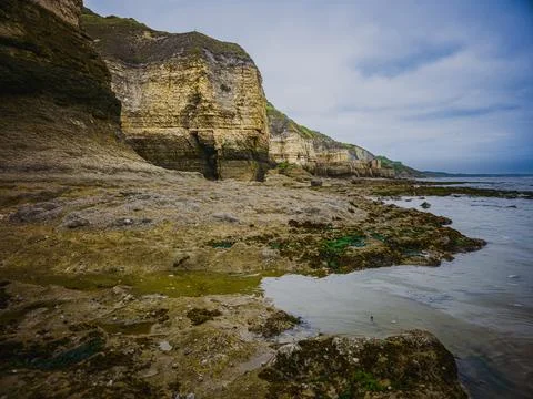 Tidal pools and coastal cliffs at low tide in Normandy France Stock Photos