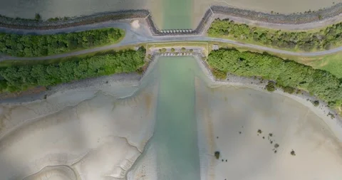 Tidal stream flowing under lagoon bridge, Mangere Lagoon, Auckland, New Zealand Stock Footage 290842667