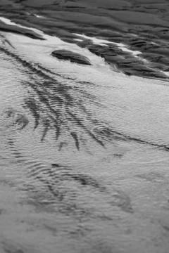 Tidal water pattern on the beach Pool of receding tidal water on the Porth... Stock Photos