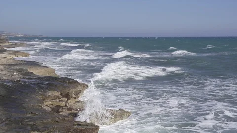 Tidal waves breaking on a rocky shore of Ancient Amathus archaeological site Stock Footage 112944014