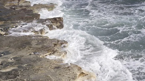 Tidal waves breaking on a rocky shore of Ancient Amathus archaeological site Stock Footage 112945830