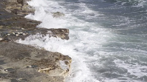 Tidal waves breaking on a rocky shore of Ancient Amathus archaeological site Stock Footage 112945941
