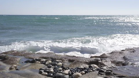 Tidal waves breaking on a rocky shore of Ancient Amathus archaeological site Stock Footage 112946496