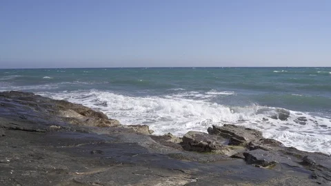Tidal waves breaking on a rocky shore of Ancient Amathus archaeological site Stock Footage 112949982