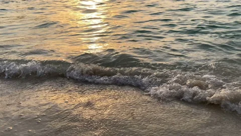 Tidal waves with foam and spray roll on the sandy beach. Stock Footage 161068715